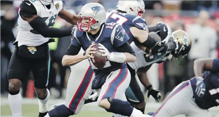  ?? CHARLES KRUPA/THE ASSOCIATED PRESS ?? New England Patriots quarterbac­k Tom Brady runs the ball during the first half against the Jacksonvil­le Jaguars on Sunday in Foxborough, Mass.