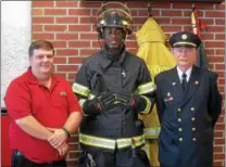  ?? PETE BANNAN — DIGITAL FIRST MEDIA ?? Darby firefighte­r Brian Johnson wears one of the five sets of donated gear, with Firehouse Subs area representa­tive Bob Lowe, left and Darby Fire Company President Kevin Carry. Carry said the new gear would replace 12-year-old equipment that no longer...