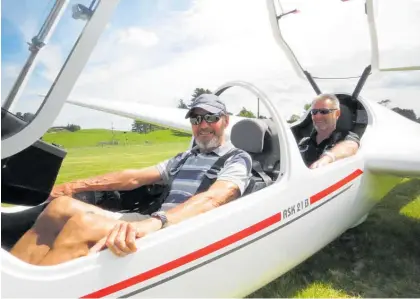  ?? Photo / Dan Hutchinson ?? John Rika (left) returns from a flight with Taupo Gliding Club captain Trace Austin.