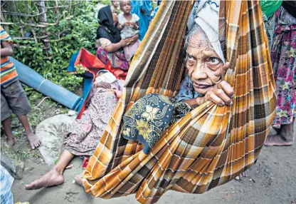  ??  ?? 105-year-old Halima and 13 of her family arrive in Bangladesh after fleeing Burma, where a further 21 family members were killed