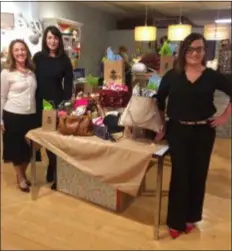  ?? KATHLEEN CAREY - DIGITAL FIRST MEDIA ?? Kathleen Rode, left, Delco District Attorney Katayoun Copeland and Candice Linehan of Delaware County Women Against Rape collect purses for crime victims as part of Small Business Saturday activities.