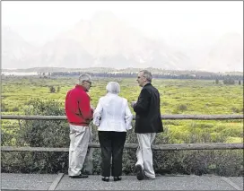 ?? BENNAN LINSLEY / AP ?? Fed Chair Janet Yellen (center), Stanley Fischer (left), vice chairman of the Fed’s Board of Governors, and Bill Dudley, president of the Federal Reserve Bank of New York, talk and view the Grand Tetons before Yellen’s speech to the annual conference...