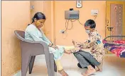  ??  ?? Sandip Bilewar (right), a visually challenged physiother­apist, working on his patient in Ambernath.