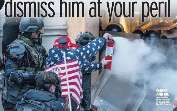  ??  ?? SMOKE AND IRE A protester fires tear gas at police near the US Capitol