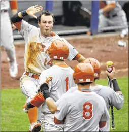  ?? SUE OGROCKI / ASSOCIATED PRESS ?? Ben Johnson (14) celebrates after Tres Barrera (1) and C.J Hinojosa (9) score against Oklahoma State in the Big 12 championsh­ip.