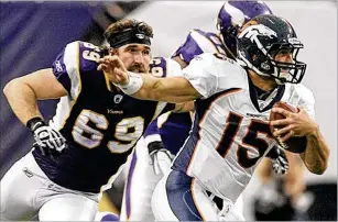 ?? MORRY GASH/ASSOCIATED PRESS ?? Vikings defensive end Jared Allen (left), who lost his helmet on the play, chases Broncos quarterbac­k Tim Tebow during a 2011 game in Minneapoli­s.