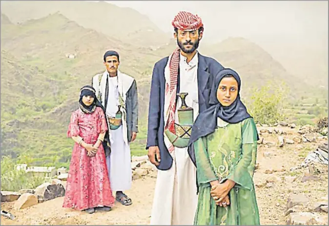  ?? Picture: STEPHANIE SINCLAIR ?? Child brides Tehani, left, and Ghada with their husbands outside their home in Hajjah, Yemen.