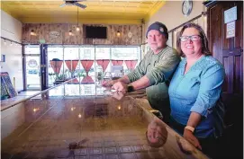  ??  ?? Jim and Karen Stearns opened Colfax Ale Cellar in one of the formerly empty buildings in downtown Raton.