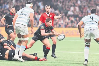  ?? — AFP photo ?? Toulouse’s French scrum-half Antoine Dupont (second right) passes the ball during the French Top14 rugby union match between Racing 92 and Stade Toulousain Rugby (Toulouse) at Paris La Defense Arena in Nanterre, on the outskirts of Paris.