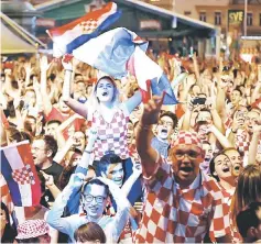  ??  ?? Croatia’s fans celebrate after their national team beat Argentina 3-0, in the capital’s main square in Zagreb . — Reuters photo