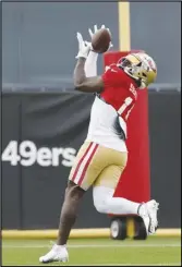  ?? Associated Press ?? San Francisco 49ers wide receiver Deebo Samuel (19) reaches for a pass during the team’s training camp practice, Monday, in Santa Clara. Samuel and the 49ers agreed, earlier this week, to a three-year, $71.6 million extension through the 2025 season.