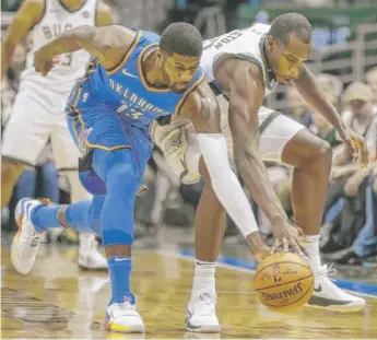  ?? | AP ?? The Thunder’s Paul George steals the ball away fromthe Bucks’ Khris Middleton on Tuesday in Milwaukee.