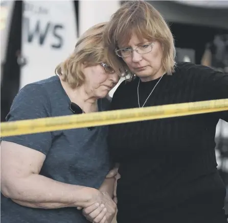  ?? PICTURE: GETTY IMAGES ?? 0 Mourners comfort each other outside the Texas church where 26 people were shot dead