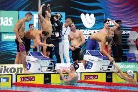  ?? AP PHOTO/PETR DAVID JOSEK ?? Members of team United States celebrate after winning the men’s 4x100m freestyle relay final at the 19th FINA World Championsh­ips in Budapest, Hungary, Saturday, June 18, 2022.