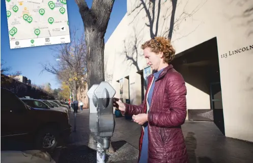  ?? OLIVIA HARLOW/THE NEW MEXICAN ?? Carly Piccarello of Santa Fe pays for parking near the Plaza. A downloadab­le smartphone applicatio­n ParkMobile, inset, now allows residents and visitors to find one of the city’s 1,145 on-street metered parking spaces.