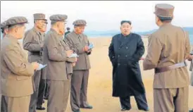  ?? AP ?? In this photo released on Friday by the North Korean government, the country’s leader Kim Jong Un listens to a military official at the Academy of National Defence Science in Pyongyang.