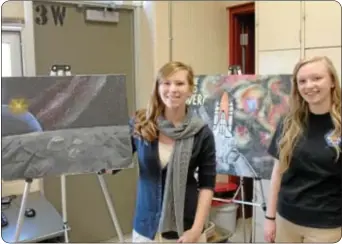  ??  ?? Council Rock senior Jen Platt, left, and junior Kat Johnston show off art work created as part of a NASAsponso­red competitio­n.