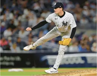  ?? ADAM HUNGER/AP ?? Yankees pitcher Ron Marinaccio throws during the eighth inning of a game against the Cubs on June 11 in New York.