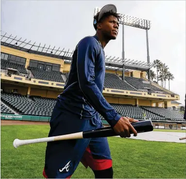  ?? CURTIS COMPTON/CCOMPTON@AJC.COM ?? Braves outfielder Ronald Acuna, rated the consensus No. 1 prospect in baseball this winter by several experts, walks to batting practice arriving early and ready to prove it.