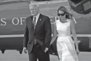  ?? EVAN VUCCI/THE ASSOCIATED PRESS ?? President Donald Trump and and his wife, Melania, hold hands Tuesday as they walk from Marine One to board Air Force One, en route to Rome, in Jerusalem. On Monday on his arrival at Ben-Gurion Internatio­nal Airport, President Trump turned and reached...