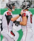  ??  ?? Atlanta quarterbac­k Matt Ryan, left, celebrates with Austin Hooper after they connected for a touchdown during the first half.