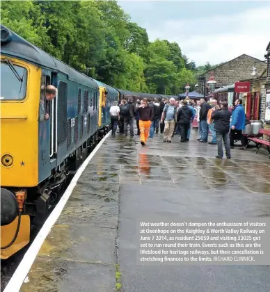  ?? RICHARD CLINNICK. ?? Wet weather doesn’t dampen the enthusiasm of visitors at Oxenhope on the Keighley & Worth Valley Railway on June 7 2014, as resident 25059 and visiting 33035 get set to run round their train. Events such as this are the lifeblood for heritage railways, but their cancellati­on is stretching finances to the limits.