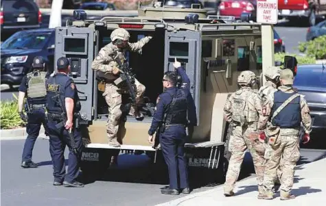  ?? AP ?? Armed law enforcemen­t personnel exit an armoured vehicle outside YouTube headquarte­rs in California. Awoman opened fire at YouTube headquarte­rs Tuesday, wounding several people before fatally shooting herself.