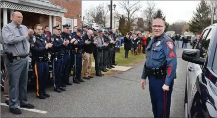 ?? TOM KELLY III — DIGITAL FIRST MEDIA ?? More than forty police officers representi­ng over a dozen area police agencies along with fire, rescue and EMS personel turned out to wish Lower Pottsgrove Township Police Sgt. Robert R. Greenwood (right) best wishes and a big thank you Thursday morning upon his retirement.