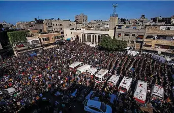  ?? AP ?? Mourners pray for a Palestinia­n family that died in a fire in their apartment building in the Jebaliya refugee camp, northern Gaza Strip, yesterday.