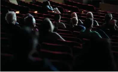  ?? DAI SUGANO — STAFF PHOTOGRAPH­ER ?? People watch a film during the Cinequest Film & Creativity Festival at the California Theatre in San Jose on Wednesday. While some venues are closing temporaril­y due to the coronaviru­s, other gathering places are operating as usual.