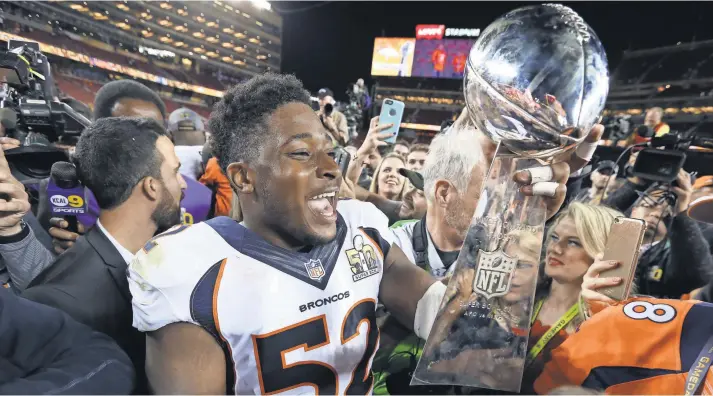  ?? MATTHEW EMMONS, USA TODAY SPORTS ?? Broncos linebacker Corey Nelson, part of a defense that held the high-scoring Panthers offense to 10 points, enjoys holding the Vince Lombardi Trophy on Sunday.