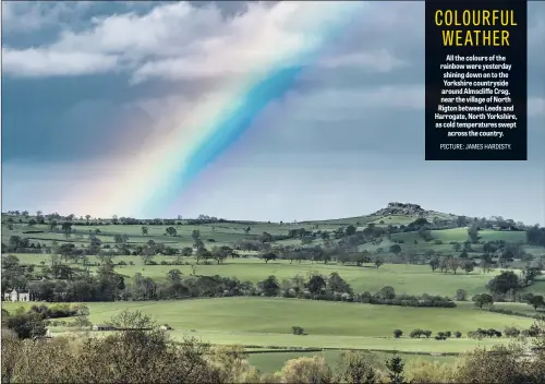  ??  ?? All the colours of the rainbow were yesterday shining down on to the Yorkshire countrysid­e around Almscliffe Crag, near the village of North Rigton between Leeds and Harrogate, North Yorkshire, as cold temperatur­es swept across the country.