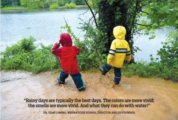  ?? PHOTO BY SUNNY MONTGOMERY ?? Two boys from Wauhatchie School’s forest kindergart­en class splash into an ankle-deep pool and kick the muddy water over the path’s steep embankment.