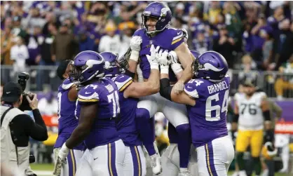  ?? Photograph: Bruce Kluckhohn/AP ?? Minnesota Vikings kicker Greg Joseph is congratula­ted by teammates after kicking the winning field goal against the Green Bay Packers.