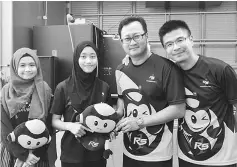  ??  ?? (From right) Wong and Ting pose for a photo after handing over the RS1 mascot to children at Kampung Jeriah.
