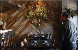  ??  ?? North’s dining room features wood paneling and a succulent wall garden.