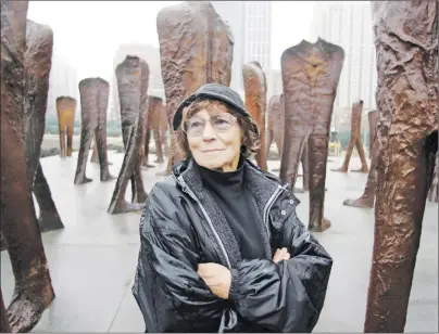  ?? AP PHOTO ?? In this file photo taken Oct. 26, 2006, Polish sculptor Magdalena Abakanowic­z stands before several of the 106 cast iron human figures, each nine feet tall, she created, as they were being installed in Chicago’s Grant Park. Adam Myjak, the rector of...