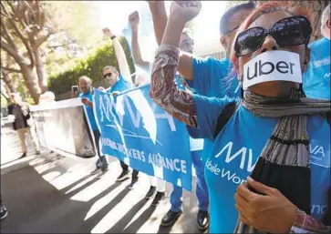  ?? Genaro Molina Los Angeles Times ?? UBER AND LYFT driver Teresa Mercado, right, joins members of the Mobile Workers Alliance, which consists of Uber and Lyft drivers, protesting at the home of Uber co-founder Garrett Camp in Beverly Hills.