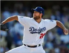  ?? (AP Photo/JAe c. hong) ?? Los Angeles Dodgers starting pitcher Clayton Kershaw throws to a Philadelph­ia Phillies batter during the third inning of a baseball game.