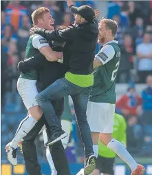  ??  ?? HIGH FIVE: Hibs midfielder Fraser Fyvie, left, revels with jubilant fans on the Hampden pitch at fulltime