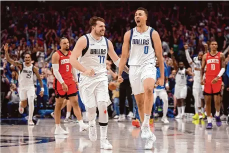  ?? Photos by Sam Hodde/Getty Images ?? The Mavericks’ Dante Exum, right, celebrates after making a buzzer-beater 3-pointer to tie the Rockets at the end of regulation.