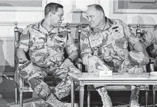  ?? John Gaps III / Associated Press ?? Chairman of the Joint Chiefs of Staff Gen. Colin Powell, left, confers with Gen. H. Norman Schwarzkop­f at a central Saudi Arabia air base in 1991. During the Gulf War, the two applied the lessons they’d learned in Southeast Asia decades before.