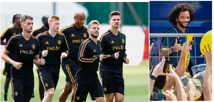  ??  ?? Looking forward: Belgium striker Dries Mertens (second from right) leading his teammates during a training session in Dedovsk yesterday. Inset: Brazil defender Marcelo gesturing towards fans outside their hotel in Kazan yesterday. — Reuters / AFP