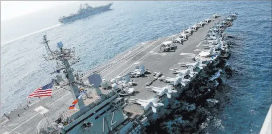  ?? The Associated Press ?? In this Friday photo released by the U.S. Navy, the USS Abraham Lincoln sails in the Arabian Sea near the amphibious assault ship USS Kearsarge.