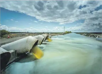  ?? Photograph­s by Tomas Ovalle ?? AFTER RECORD RAINS in Northern California, agencies across the state’s vast f lood-control network are coordinati­ng for a massive influx of snowmelt. Above, a lift in the Fresno Slough Water District.