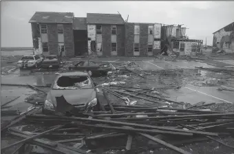  ?? TRIBUNE NEWS SERVICE ?? Wrecked cars and building debris show evidence of the severity of Hurricane Harvey after it passed through Saltgrass Estates apartments in Rockport, Texas, destroying the complex, on Aug. 26.