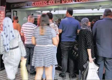  ?? PHOTO: AP ?? People queue outside a currency exchange shop in Istanbul. Turkey was hit by a financial shockwave on Friday as its currency nosedived on concerns about its economic policies and a dispute with the US. The lira hit a record low and has fallen 66 percent since the start of the year.