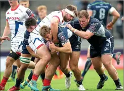  ??  ?? HELD UP: Connacht’s Kyle Griffin cannot get through the tackle of Sale man WillGriff John during yesterday’s match