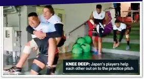  ??  ?? KNEE DEEP: Japan’s players help each other out on to the practice pitch