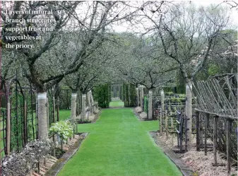  ??  ?? Layers of natural branch structures support fruit and vegetables at the priory.